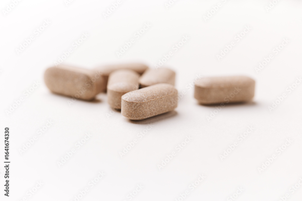 Lion’s mane mushrooms tablets that have beneficial effects on the body, especially the brain, heart, and intestines. Bright paper background. Soft focus. Close up. Copy space. Lion’s mane mushrooms tablets that have beneficial effects on the body, especially the brain, heart, and intestines. Bright paper background. Soft focus. Close up. Copy space.