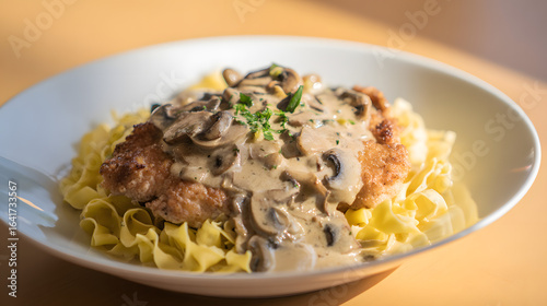 Delicious Veal Escalope with Creamy Mushroom Sauce Served on a Bed of Egg Noodles