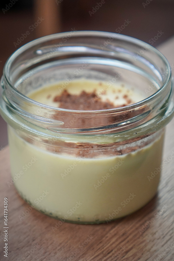 Individual dessert jar with creamy interior and decorative sprinkle Individual dessert jar with creamy interior and decorative sprinkle