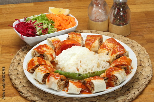 Chicken Doner wrapped in thin lavash bread with beyti sauce, butter and seasonal salad