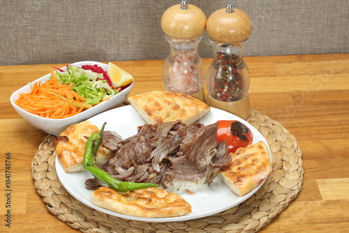 meat döner on rice, roasted tomatoes, peppers and green salad