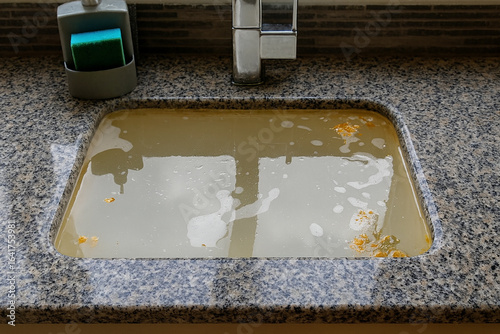 Overflowing kitchen sink, clogged drain. clogged drains, plumbing problems. Water contamination, or kitchen cleaning tasks
