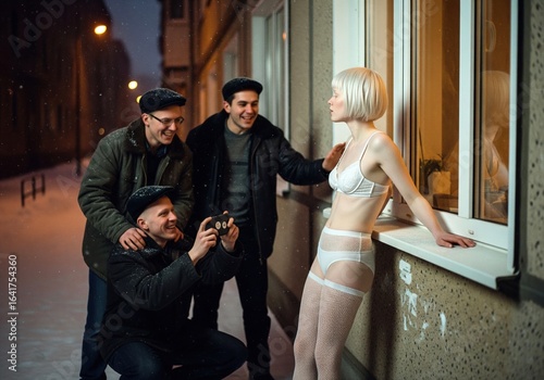 A group of friends in winter are admiring a young woman in underwear, who leaned against a window in the evening, snowy weather with a street lamp on a city street at night