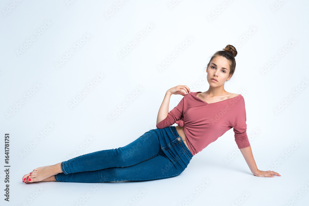 Beautiful young smiling woman with clean perfect fresh skin sits on the floor. Portrait of beauty model with natural make up, formed eyebrows and long eyelashes. Spa, skincare and wellness Beautiful young smiling woman with clean perfect fresh skin sits on the floor. Portrait of beauty model with natural make up, formed eyebrows and long eyelashes. Spa, skincare and wellness
