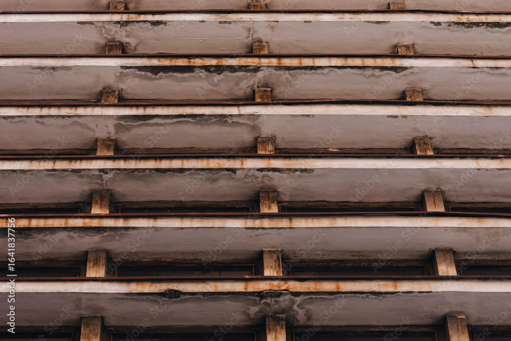 Fototapeta premium Rust-Stained Concrete Beams and Columns in Brutalist Parking Structure