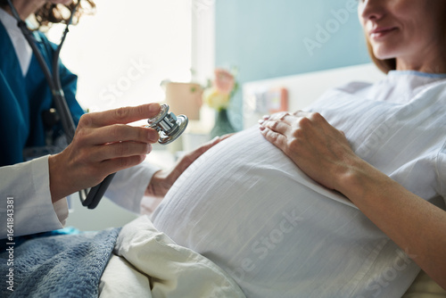 Photos Caucasian pregnant woman sitting during medical examination with female doctor h