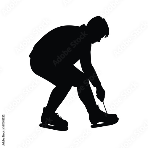Silhouette of an ice skater tying skates