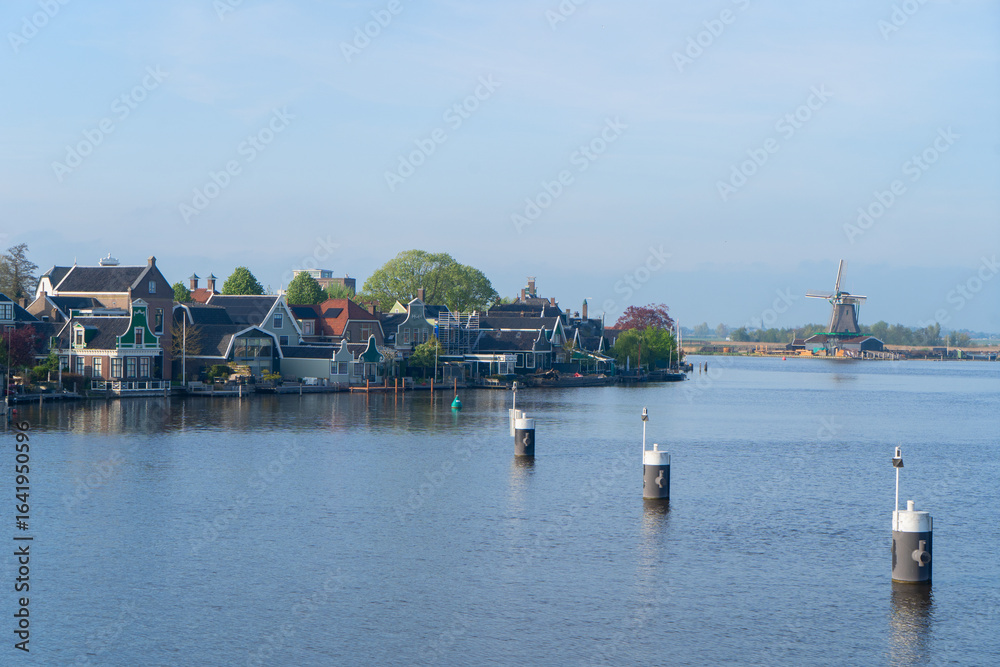 Obraz premium rural dutch country skyline of small old town Zaanse Schans with fog, Netherlands