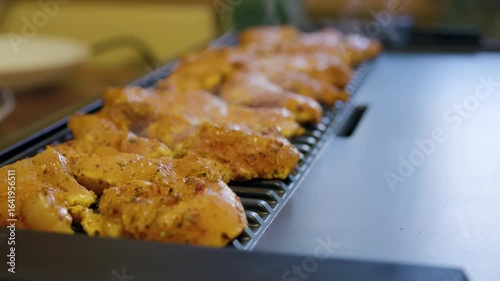 cooking chicken fillet on an electric grill at home