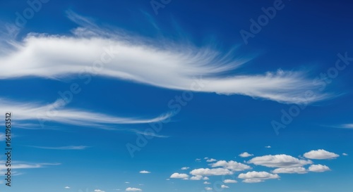 Blue sky with white cirrus clouds, a bright sunny day with light clouds background