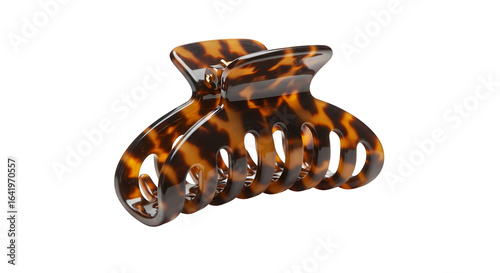 Brown tortoiseshell claw clip gleams on black. Styling accessory. Perfect for e-commerce, product catalogs, and fashion ads.