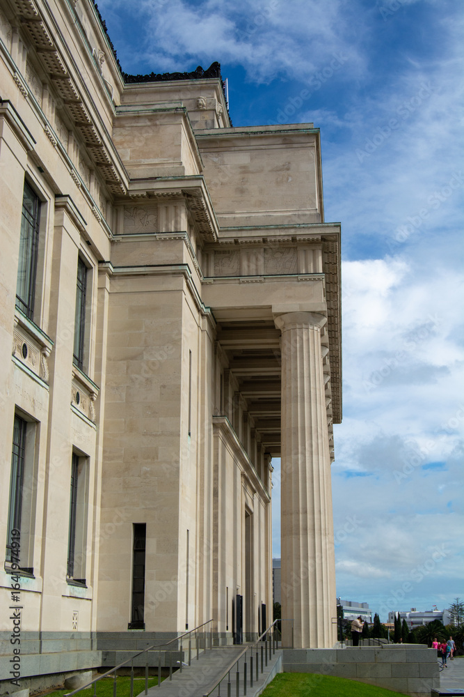 Fototapeta premium Grand Architectural Building with Columns Against Blue Sky