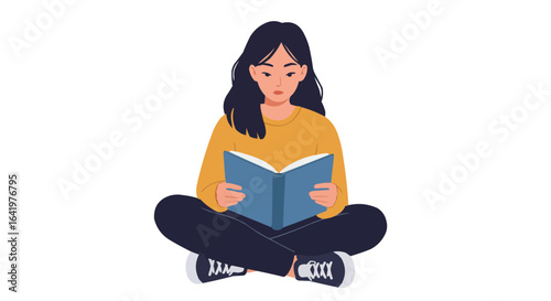 Young woman with dark hair sitting cross legged and reading a book with a blue cover intently on transparent background