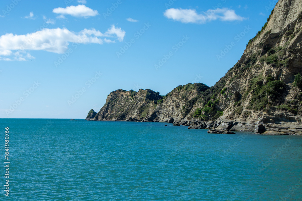 Serene Coastal Landscape with Rocky Cliffs and Turquoise Waters Serene Coastal Landscape with Rocky Cliffs and Turquoise Waters