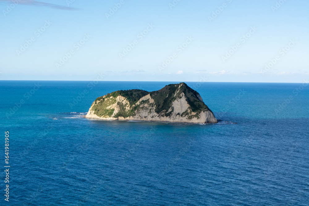 Fototapeta premium Solitary Island in Calm Blue Waters