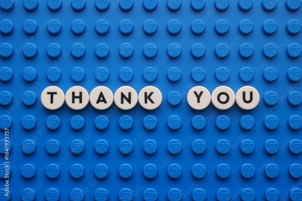 Naklejka premium Tambov, Russian Federation - August 11, 2025 The appreciation phrase Thank You on a blue Lego baseplate. The scene is made out of Lego dots.