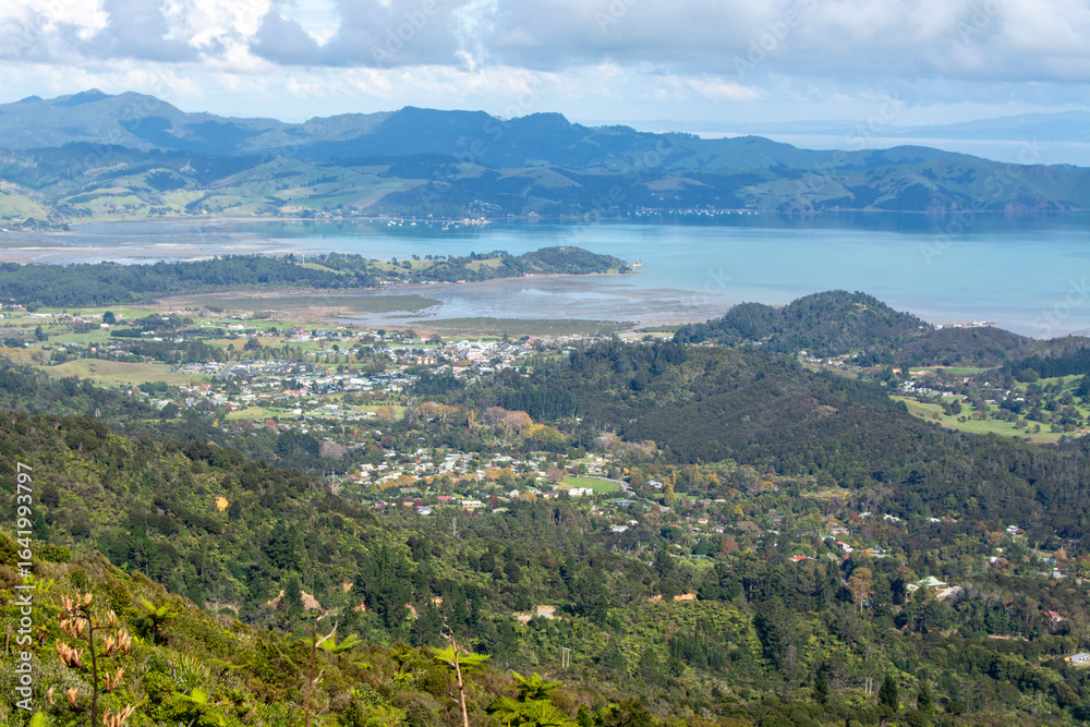 Fototapeta premium Panoramic Coastal View with Lush Green Hills