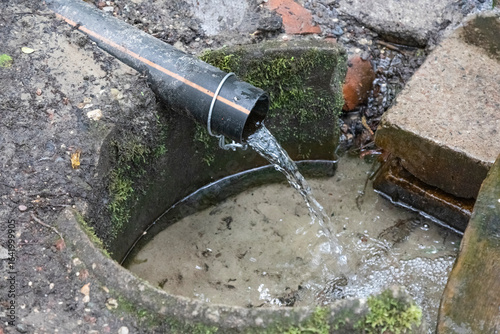 Water flowing out of a plastic pipe.