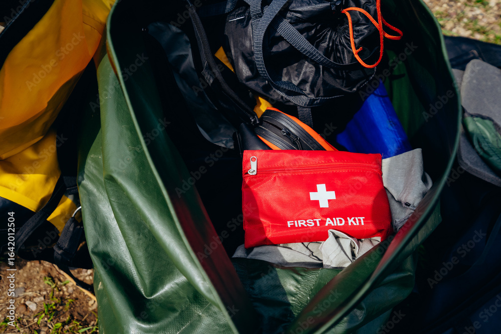 Fototapeta premium A closeup view of a first aid kit carefully placed among various camping gear, highlighting the critical importance of being safe and wellprepared for any outdoor adventure or activity that arises