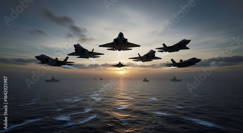 A squadron of stealth fighter jets flies in formation over a naval fleet at sunset