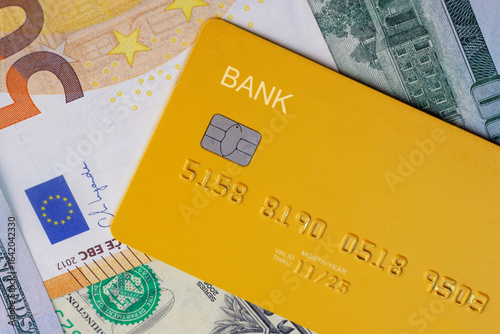 Photos Credit card laying on top of  the cash of money