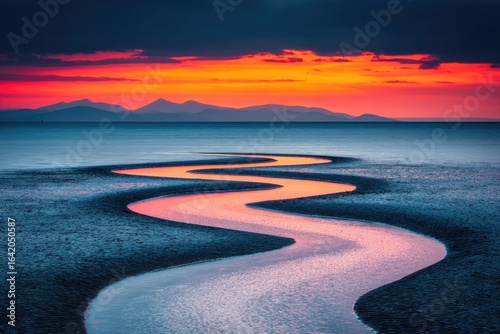Fototapeta Naklejka Na Ścianę i Meble -  Serpentine waterway at sunset reflecting vibrant hues.