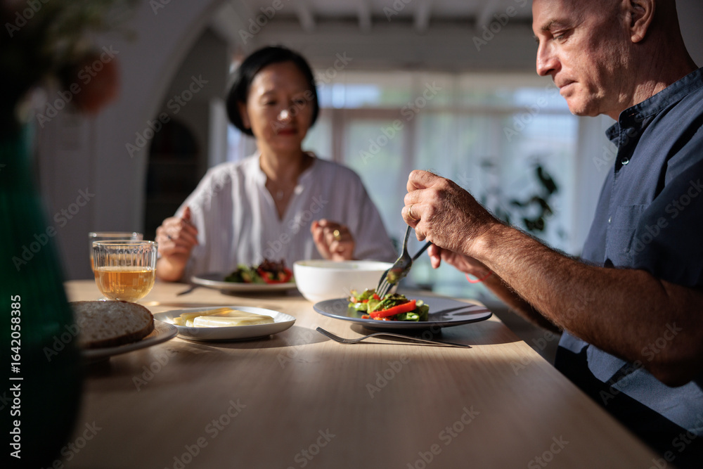 Couple enjoying a light lunch with salad and drinks. Couple enjoying a light lunch with salad and drinks.