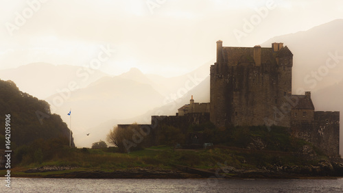 Eilean Donan Castle on Loch Duich near Dornie in the Scottish Highlands shrouded in mist and moody atmospheric light.