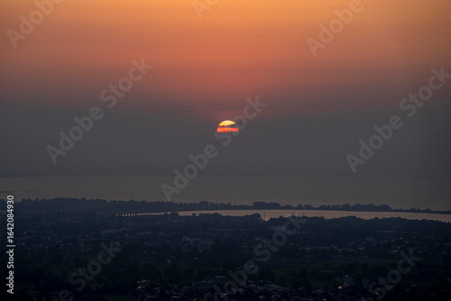 Wallpaper Mural hazy misty sunset in orange and red over Lake Constance seen from high up in Bildstein, Vorarlberg ,Austria Torontodigital.ca