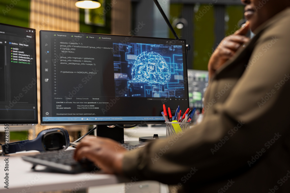 Fototapeta premium Close up of IT specialist in tech startup using artificial intelligence on PC to optimize performance and forecast issues. Technician in office training deep learning models using computer