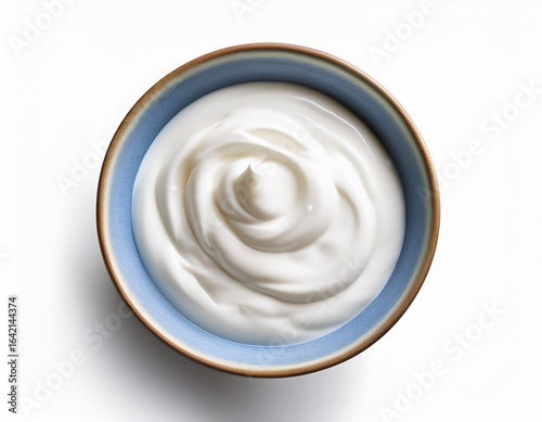 white ceramic bowl of skyr yoghurt isolated on white from above