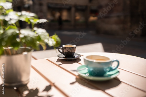 Two cups of coffee standing on a table in a street cafe
