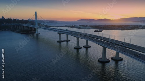 Wallpaper Mural Aerial view of the San Francisco-Oakland Bay Bridge at sunset, with cars commuting. The bridge connects San Francisco and Oakland, California, USA. Torontodigital.ca