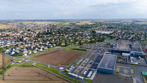 Aerial view of suburban european town with farmland and commercial areas.
