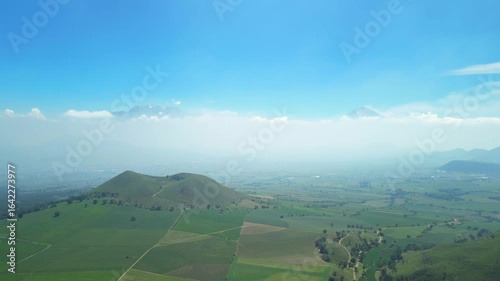 Aerial view of the Popocatépetl volcano in Mexico, seen from beautiful meadows. Mountains and volcanoes of Mexico, travel and vacation concept, 4k nature.
