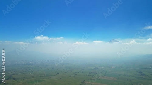 Aerial view of the Popocatépetl volcano in Mexico, seen from beautiful meadows. Mountains and volcanoes of Mexico, travel and vacation concept, 4k nature.
