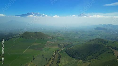 Aerial view of the Popocatépetl volcano in Mexico, seen from beautiful meadows. Mountains and volcanoes of Mexico, travel and vacation concept, 4k nature.
