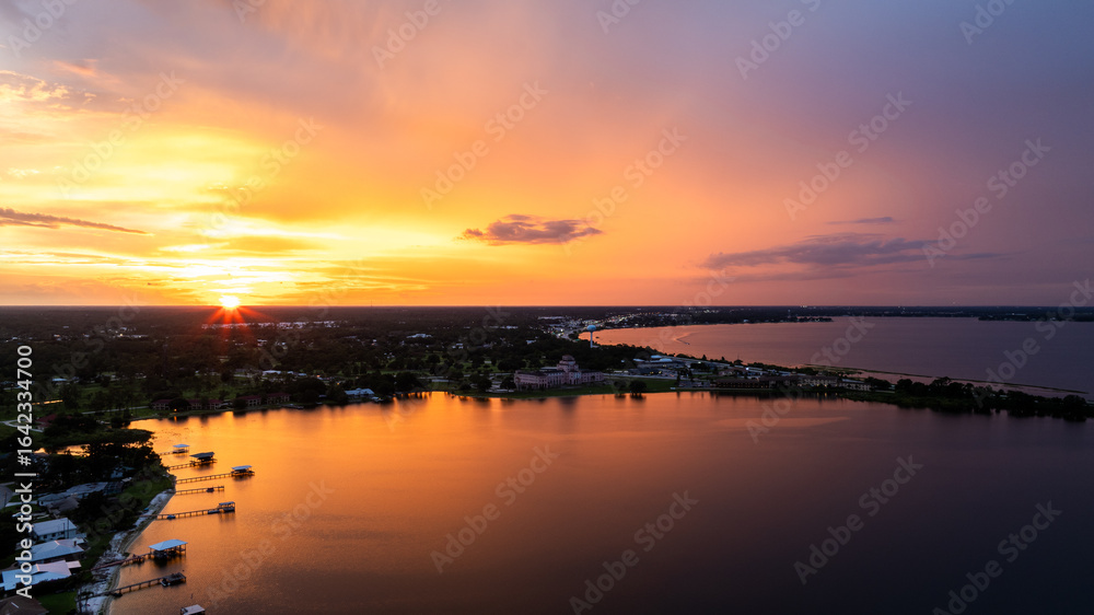 Obraz premium Aerial Drone View of Lake Jackson, Sebring Florida at Sunset with Vibrant Sky Reflections 