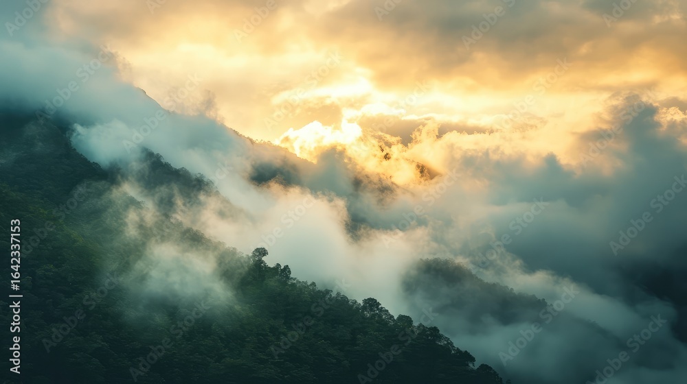 Fototapeta premium A mountain covered in clouds with a sun in the sky