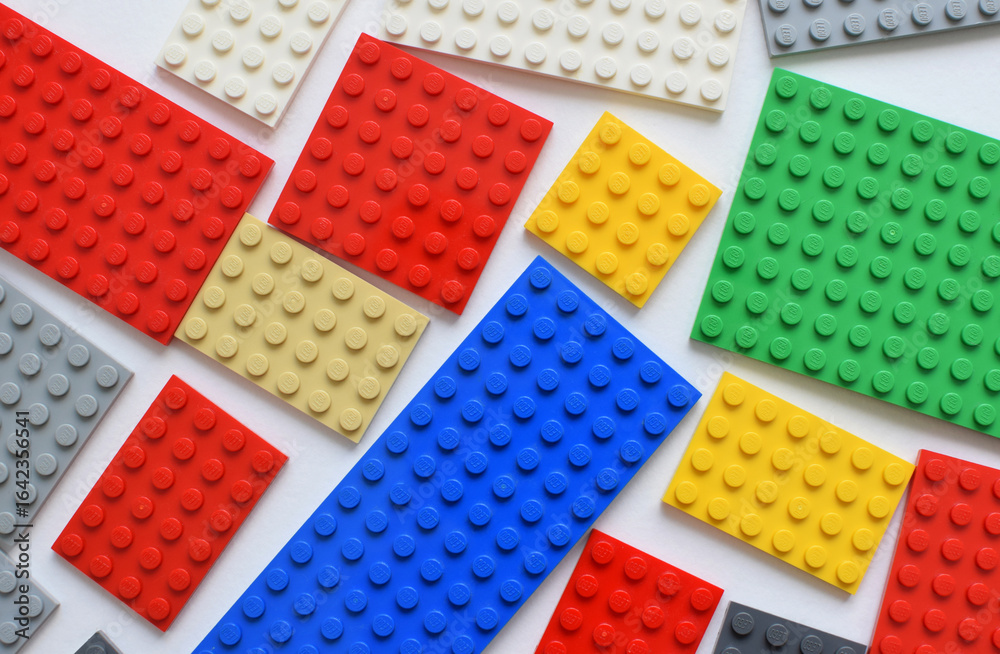 Naklejka premium Krasnodar, Russia - July 25, 2025 Children's Lego construction set - multi-colored bricks on a white background. Background made of Lego elements.