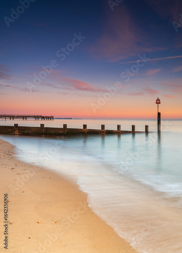 Bournemouth beach illuminated by the setting sun at sunset