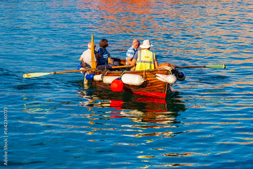 Naklejka premium Rowing passengers across water in Weymouth, England