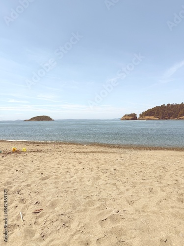 Sandy beach with ocean and small islands in background