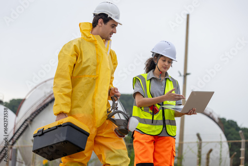 Environmental Workers Inspecting Industrial Site, Team in Protective Gear Surveying Contaminated Area, Engineer Team Assessing Safety at a Chemical Plant