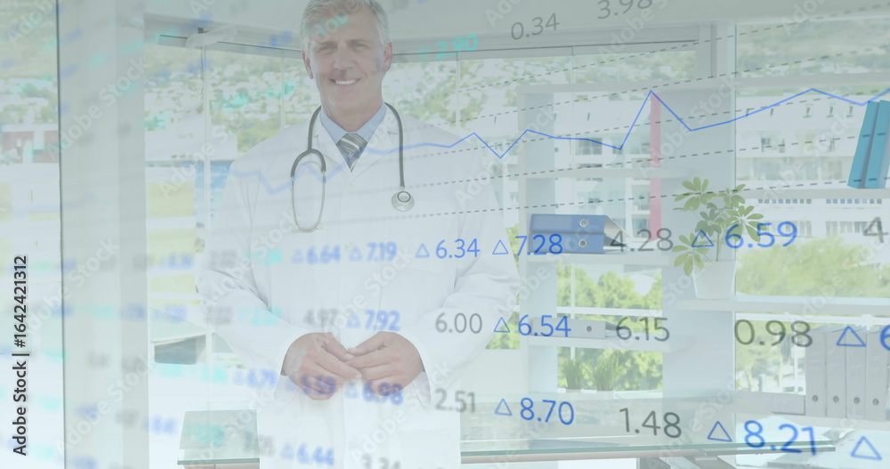 Standing male doctor wearing white lab coat smiling in office, with stethoscope and data overlays Standing male doctor wearing white lab coat smiling in office, with stethoscope and data overlays