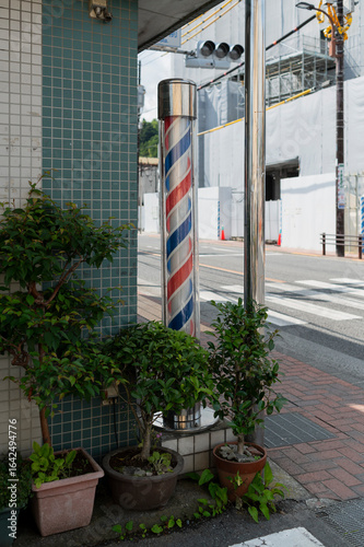 Traditional barber pole outside street corner shop