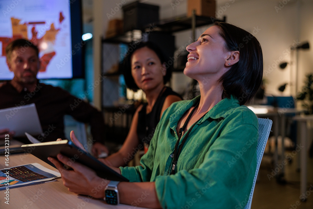 Teamwork, happy woman with tablet in a business meeting, working late Teamwork, happy woman with tablet in a business meeting, working late