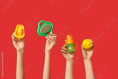 Female hands with baby bott...