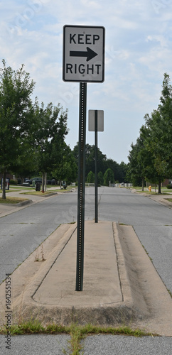 Sign on a traffic calming median saying Keep Right
