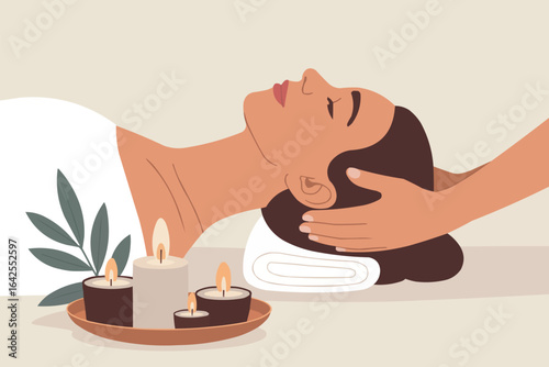Woman receiving head massage with candles and plant